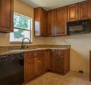 Before and after: Rehabilitation of this home in Florida included a kitchen with new appliances, cabinets, and flooring, making it ready for a low-income family looking for an affordable home to buy. (Florida Minority Community Reinvestment Coalition)